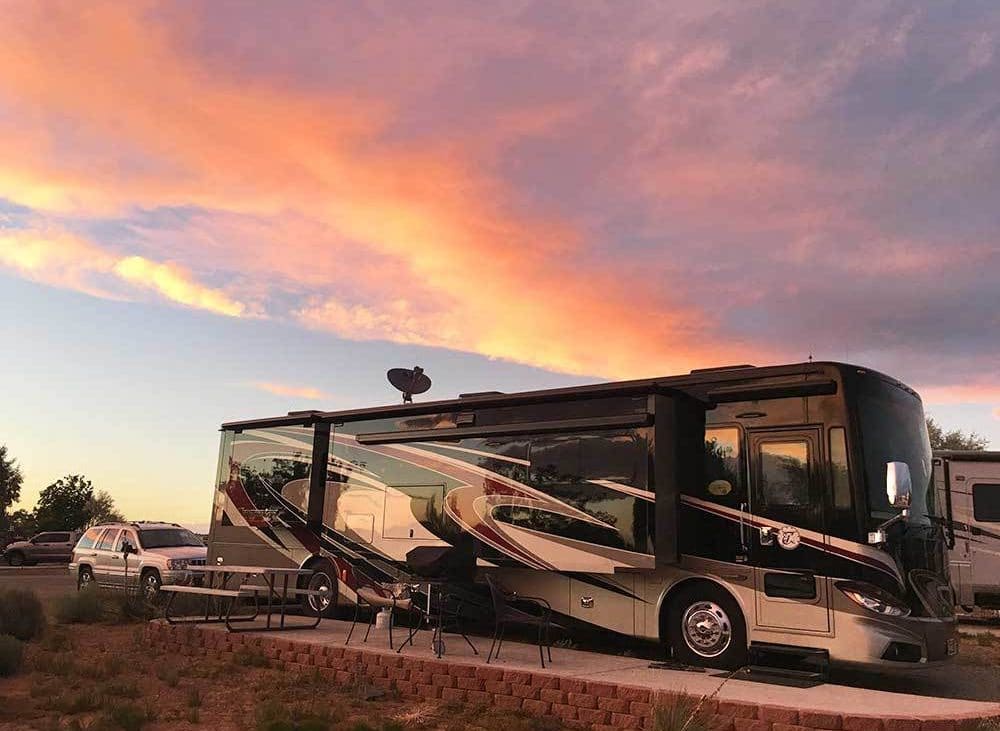 Santa Fe Skies RV — Motorhome parked under dusky sunset skies.