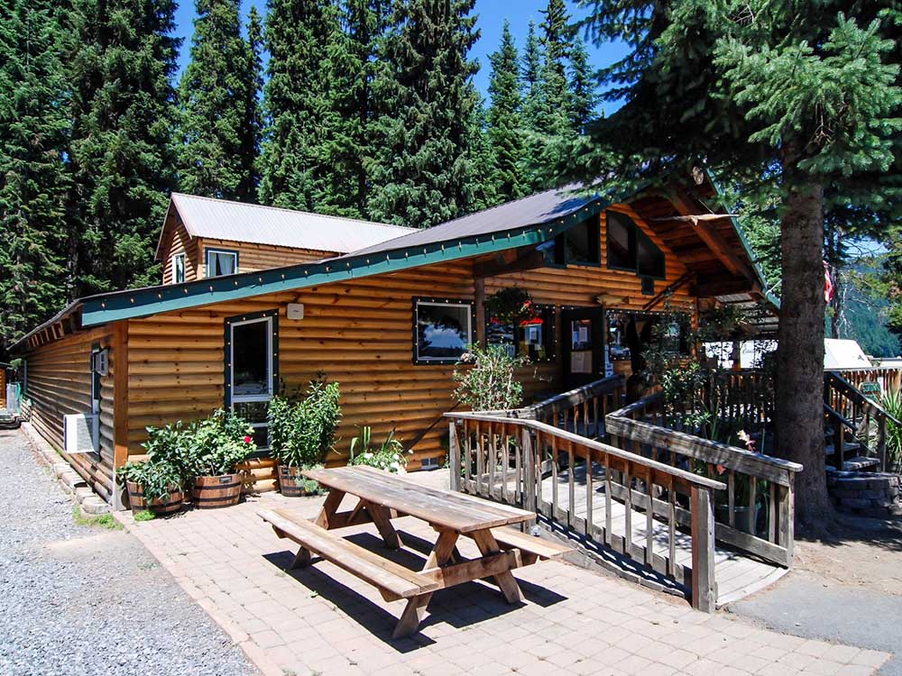 A log-cabin-style building with colorful signage inside. 