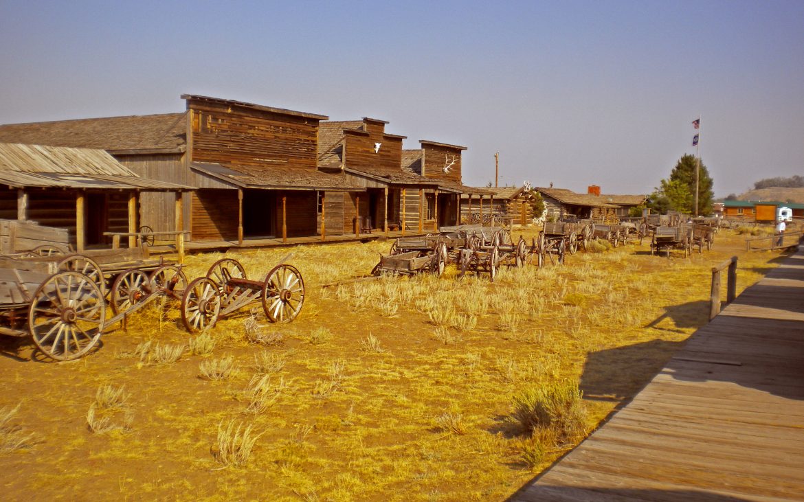 A deserted dirt street in an Old West ghost town.