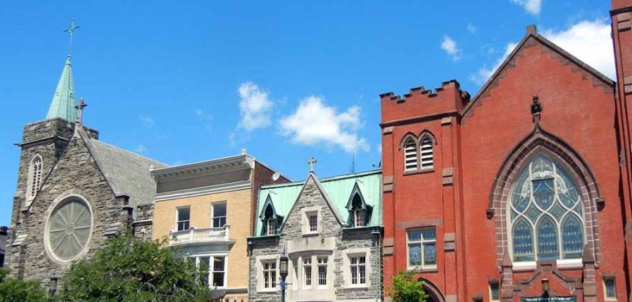 A row of elegant religious buildings in a city.
