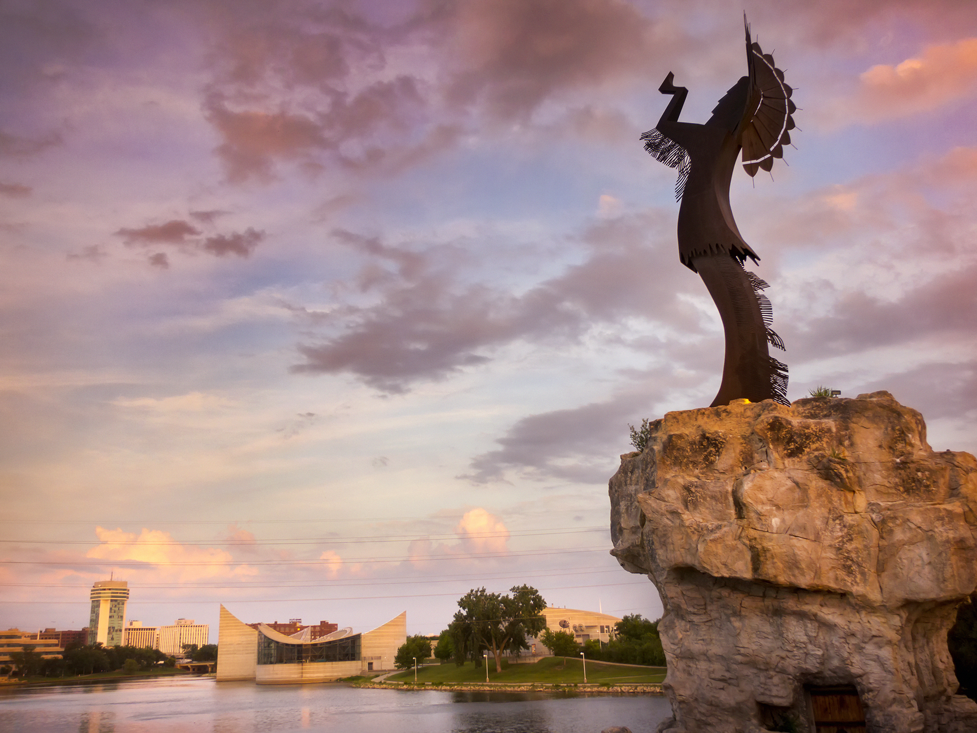 Statue of Native American Shaman overlooking river. 