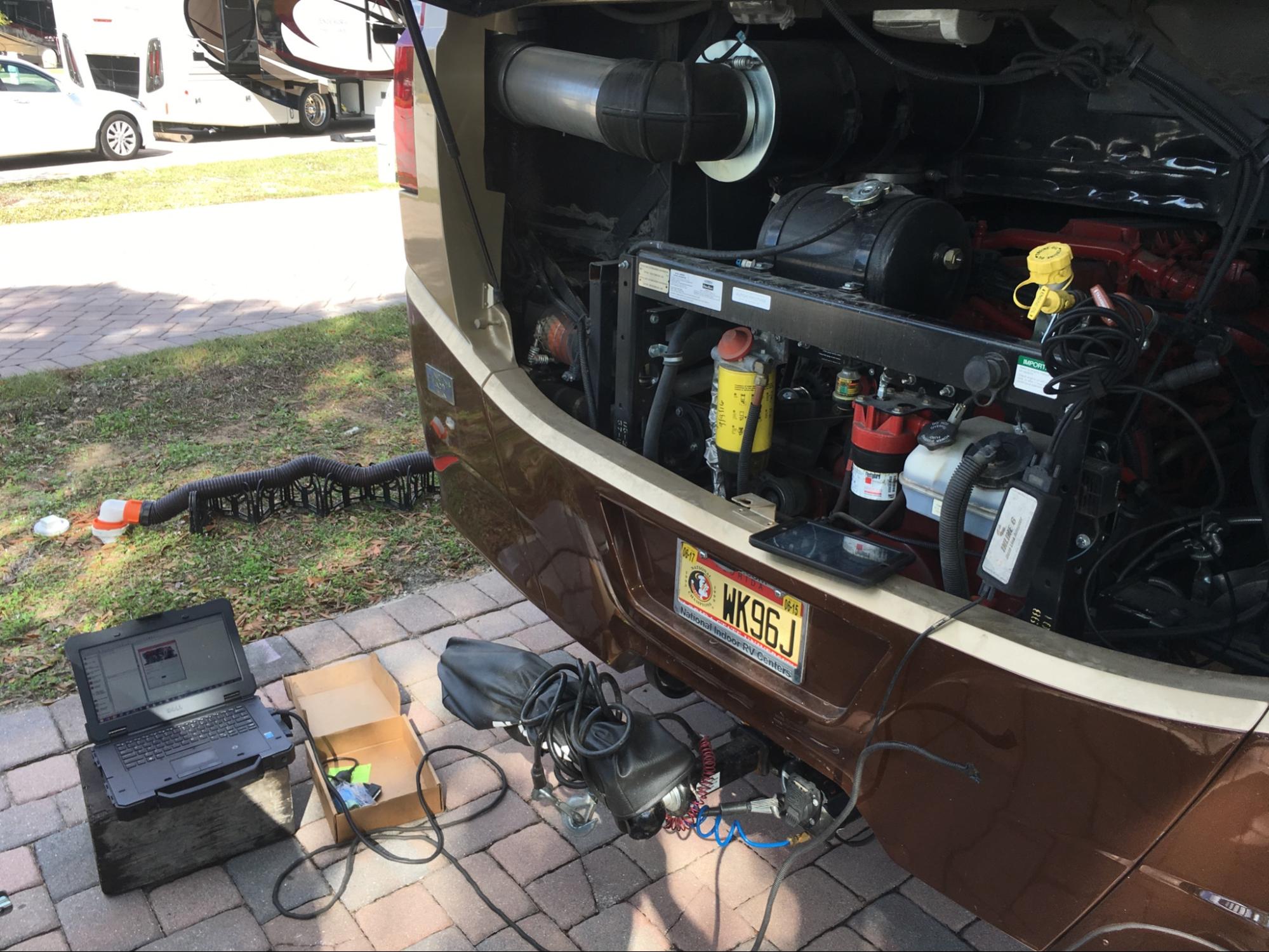 A laptop hooked up to a diesel pusher engine for maintenance.