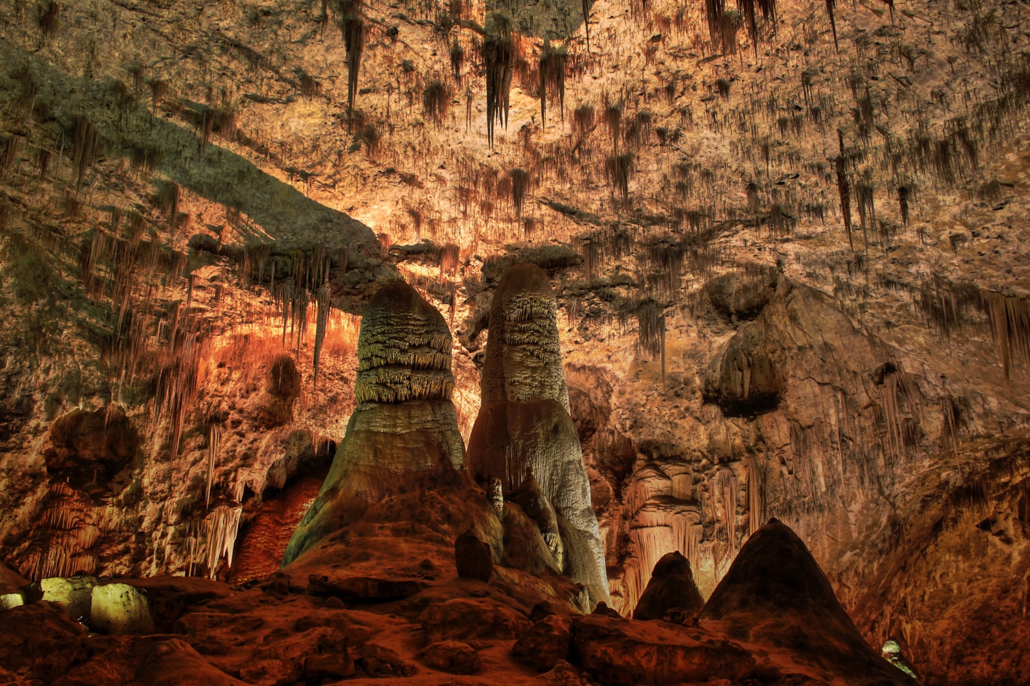 Stalagtites and stalgmites proliferate in a cave environment. 