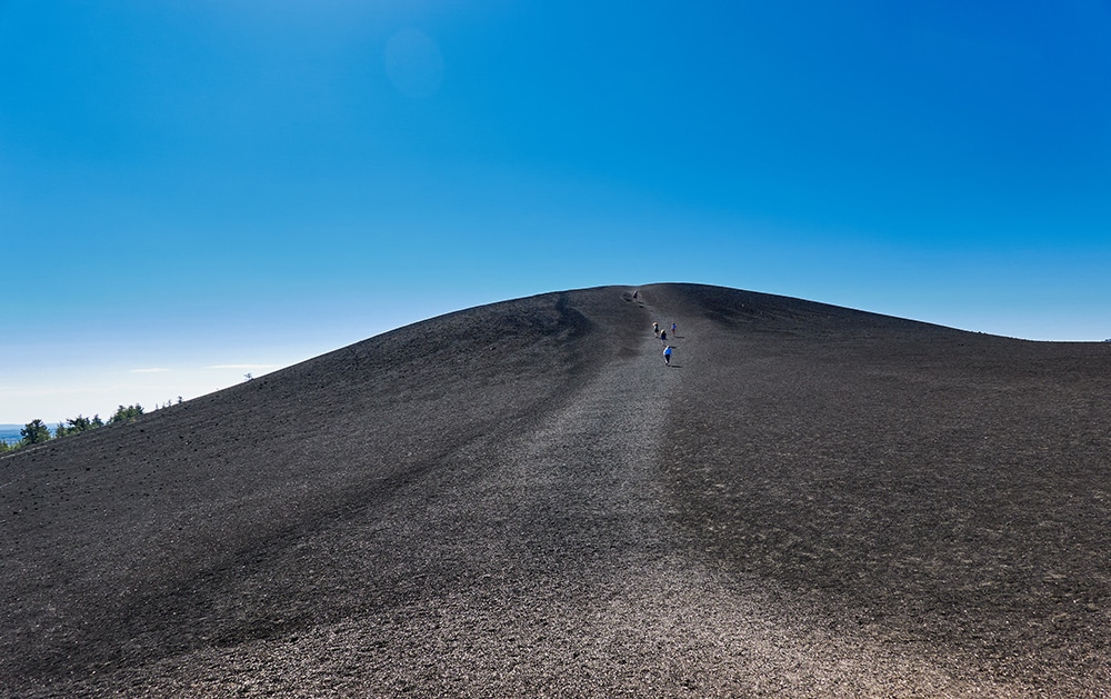 Ascending an ashy mountain on a straight trail.