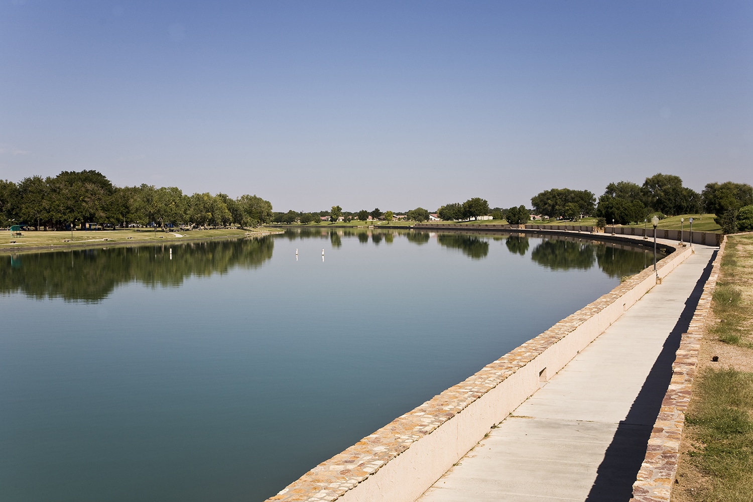 Image of a long, thin lake bordered by concrete embankments.