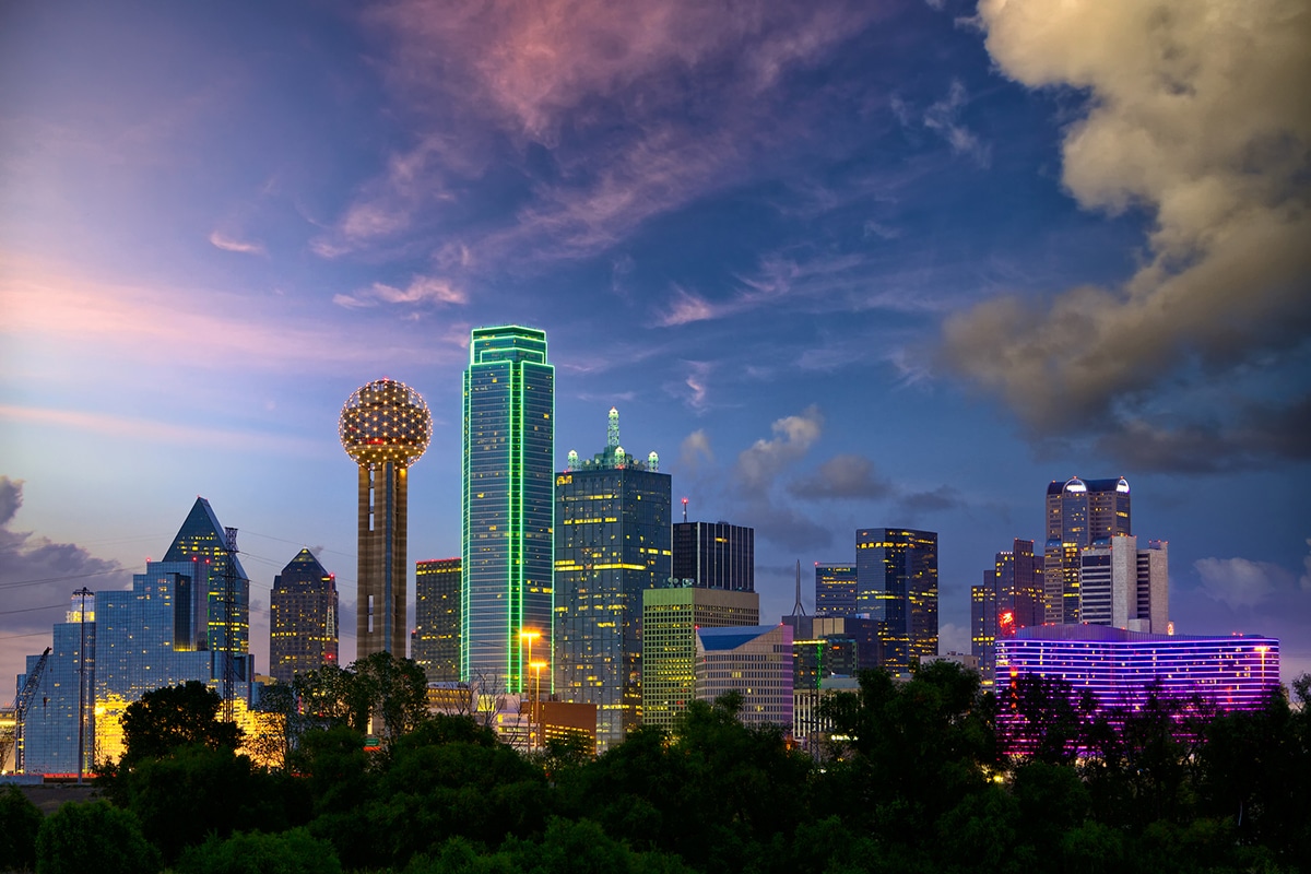 Bright lights of a metropolis against a twilight sky.