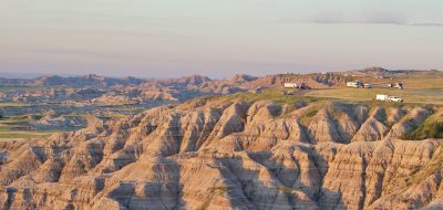 Aerial shot of RVs on a bluff in a badlands area.