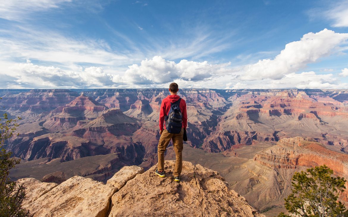 First camping trip — lone hiker looks out over vast canyon