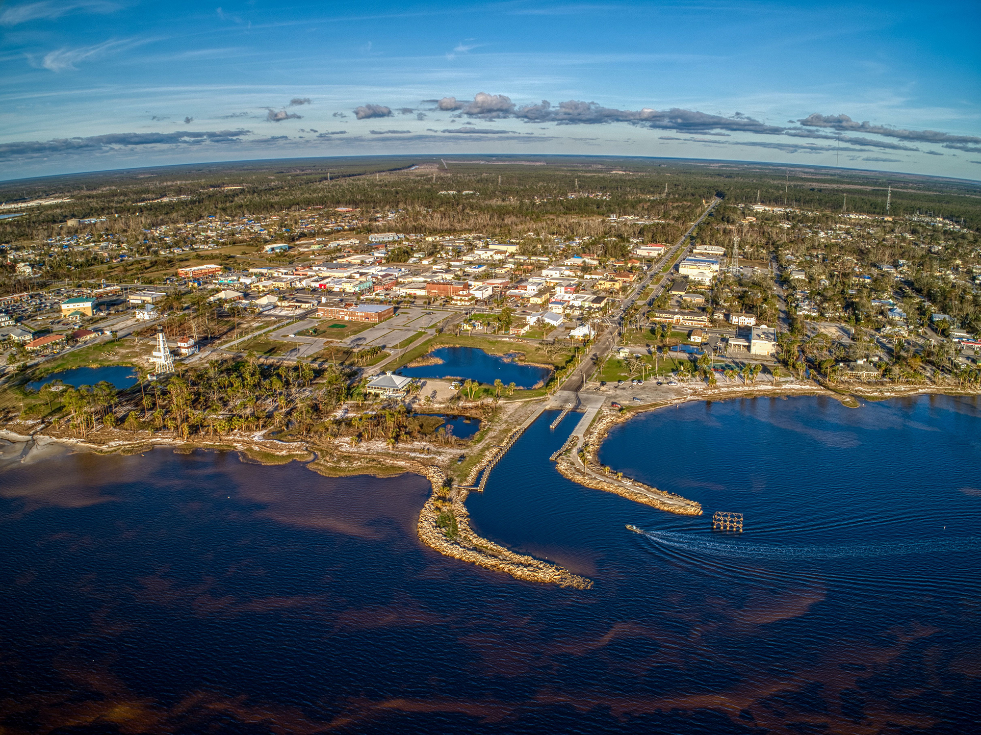 Aerial view of a marina and small coastal town.