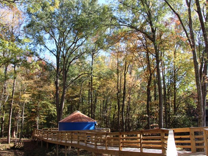 A bridge crossing leading to a yurt