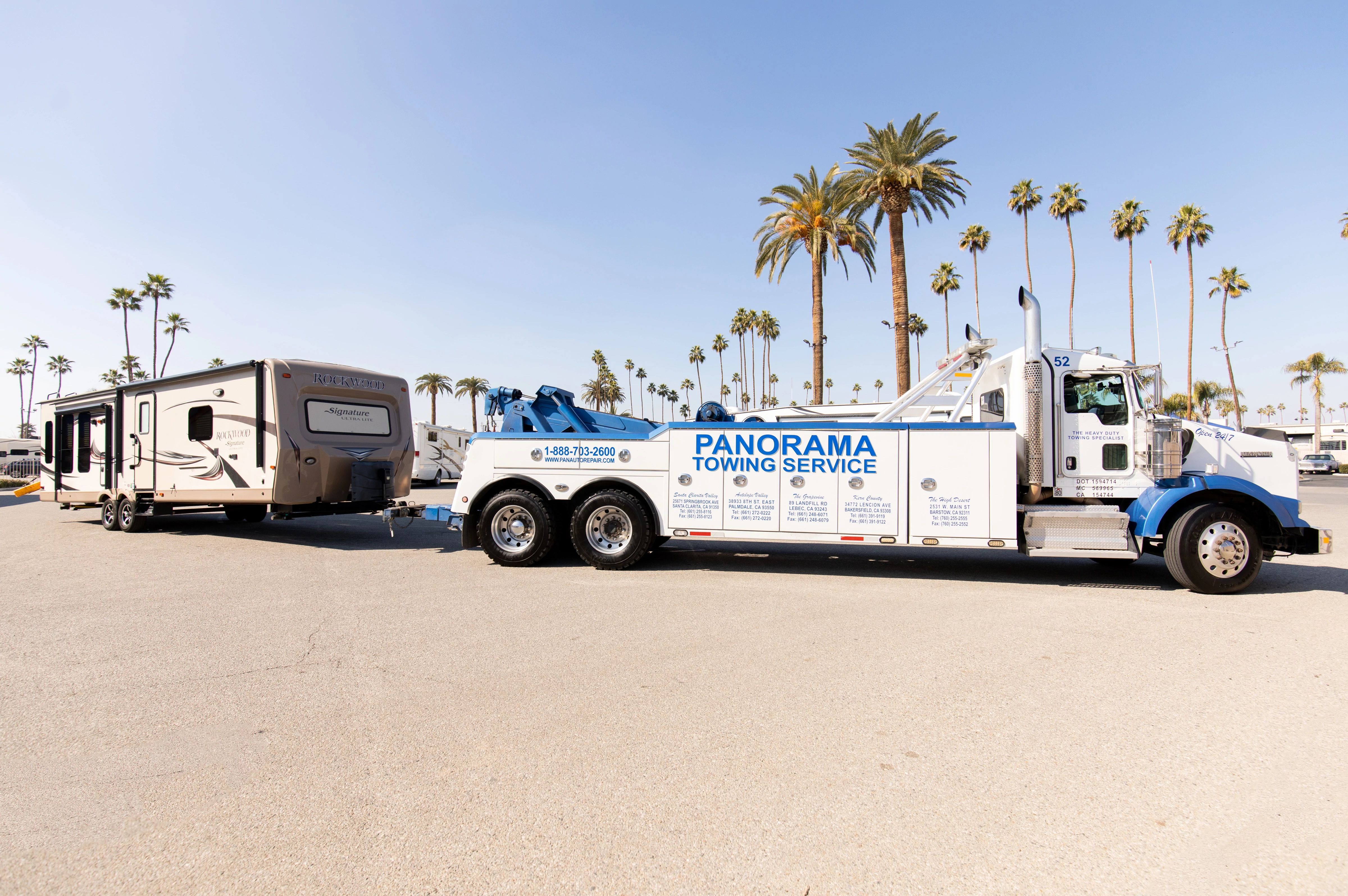 Large tow truck hauling a trailer