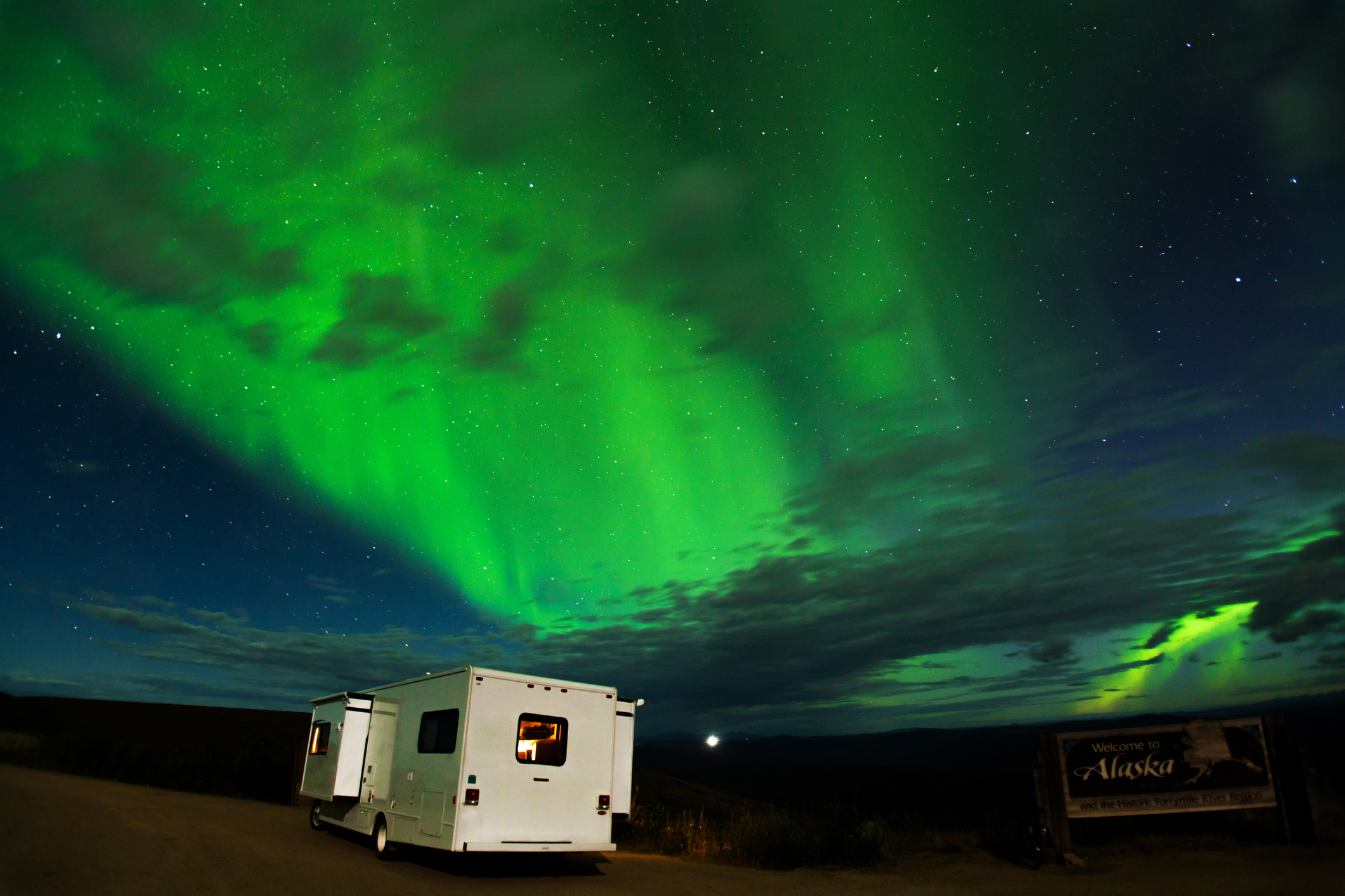 Motorhome parked under the northern lights.
