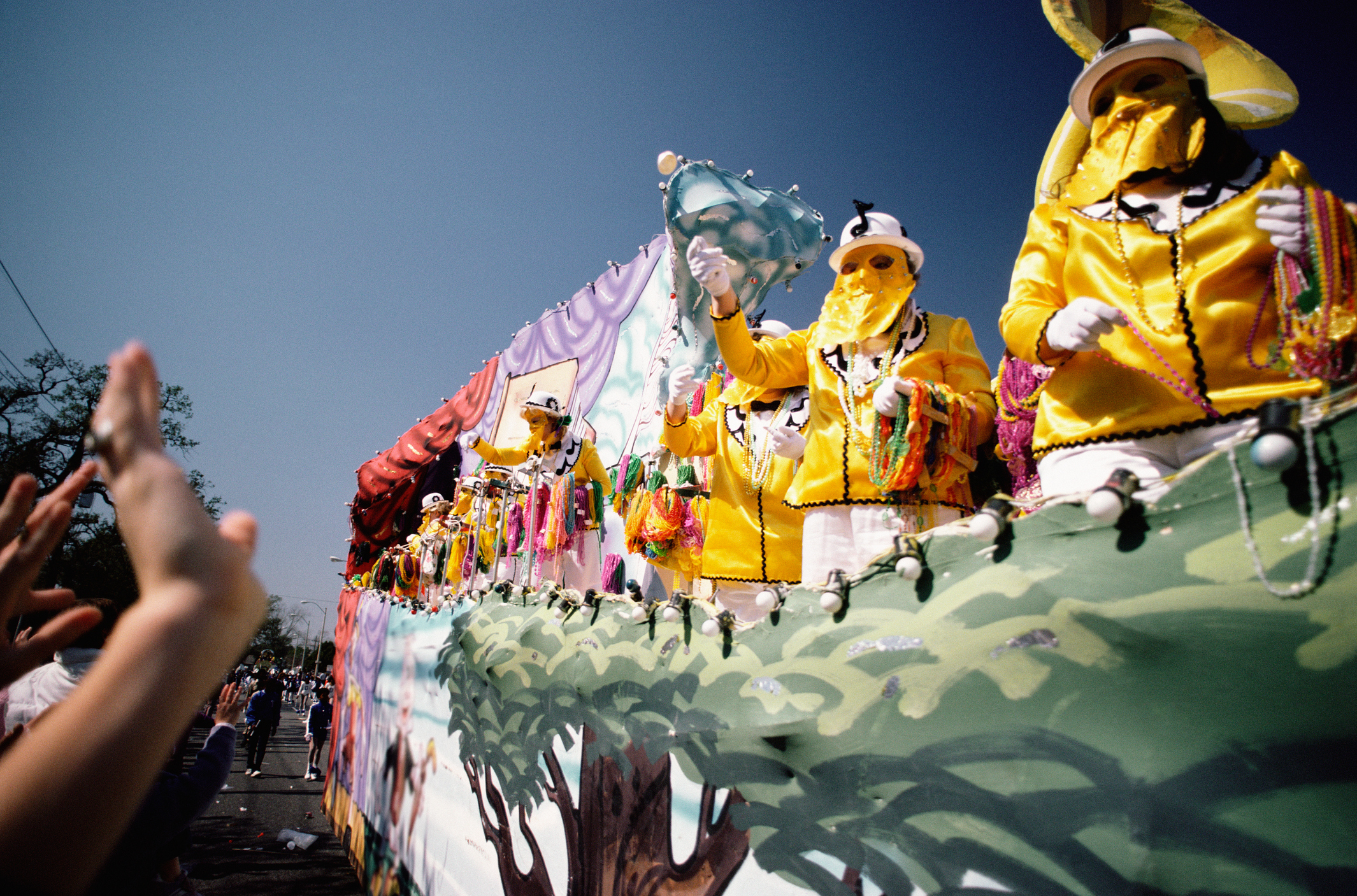 Mardi Gras revelers riding on a float.