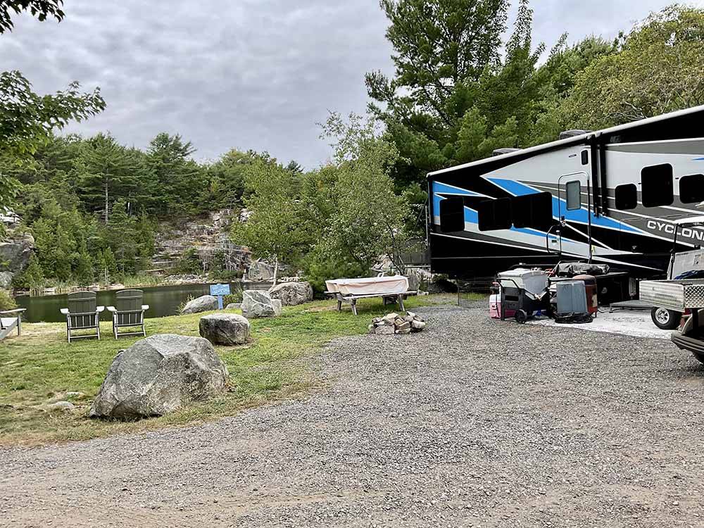 Campground with fifth-wheel and boulders demarcating spaces.