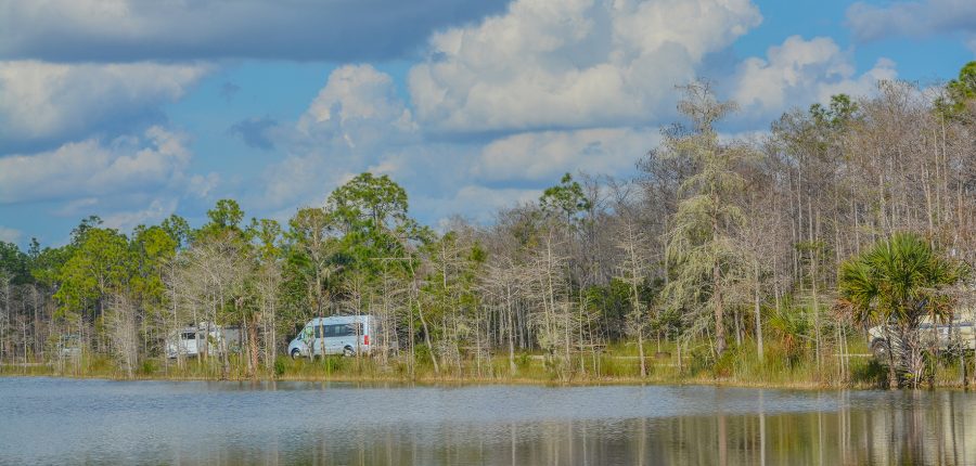 RVs camping near a lake.
