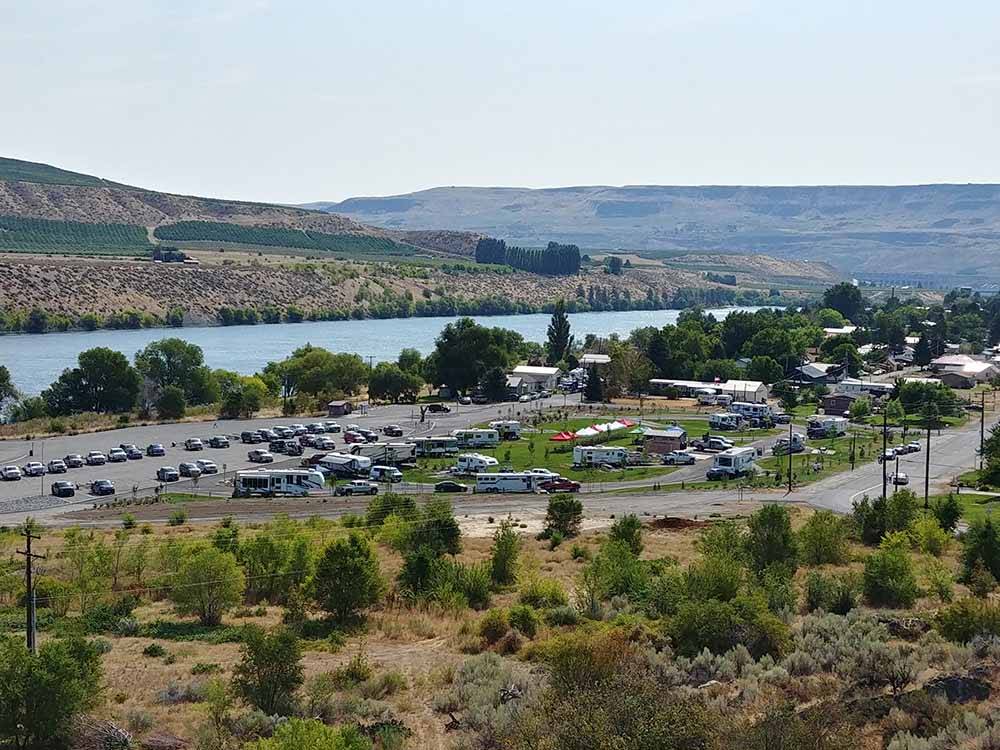 An RV park on the banks of a wide river. 