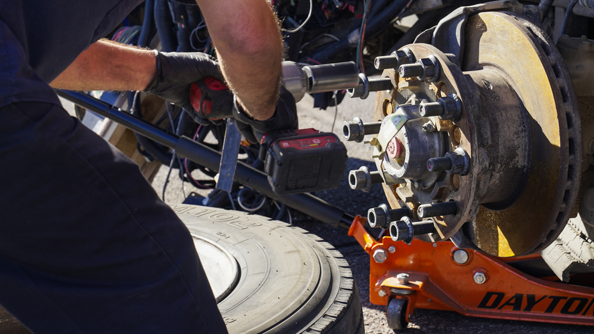 RV tech repairs a wheel hub.
