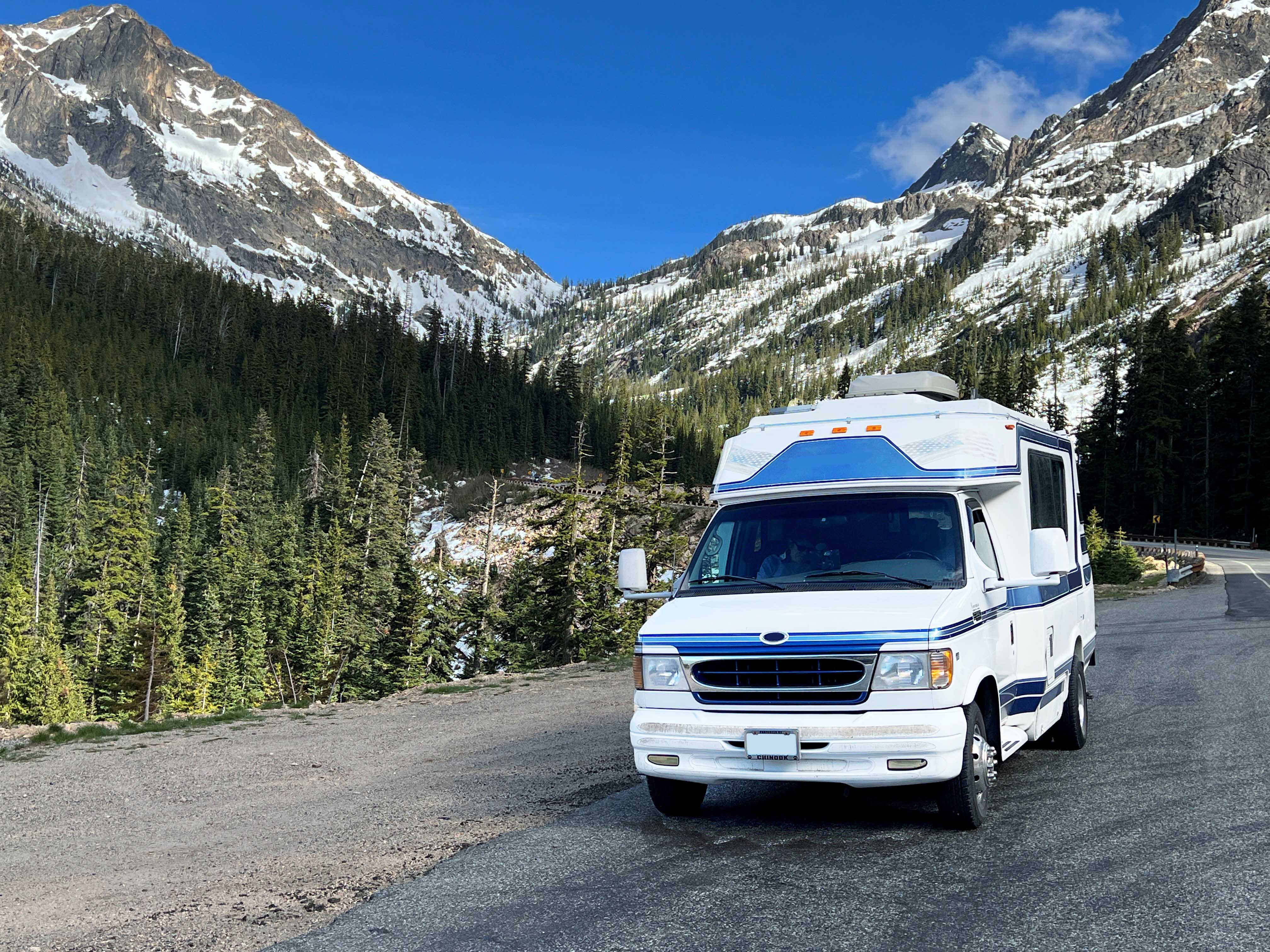 Class B motorhome parked on side of a winter road.