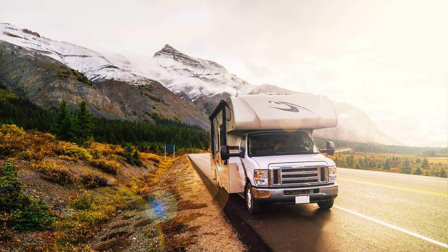 Truck camper on side of highway.