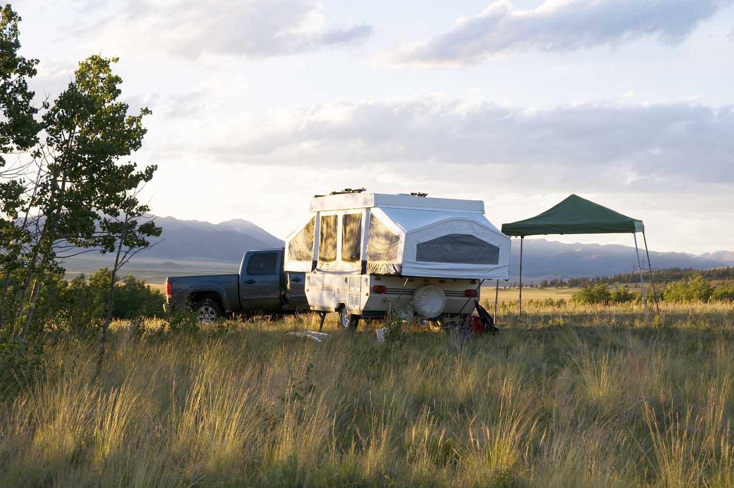 Popup camper in Colorado meadow.