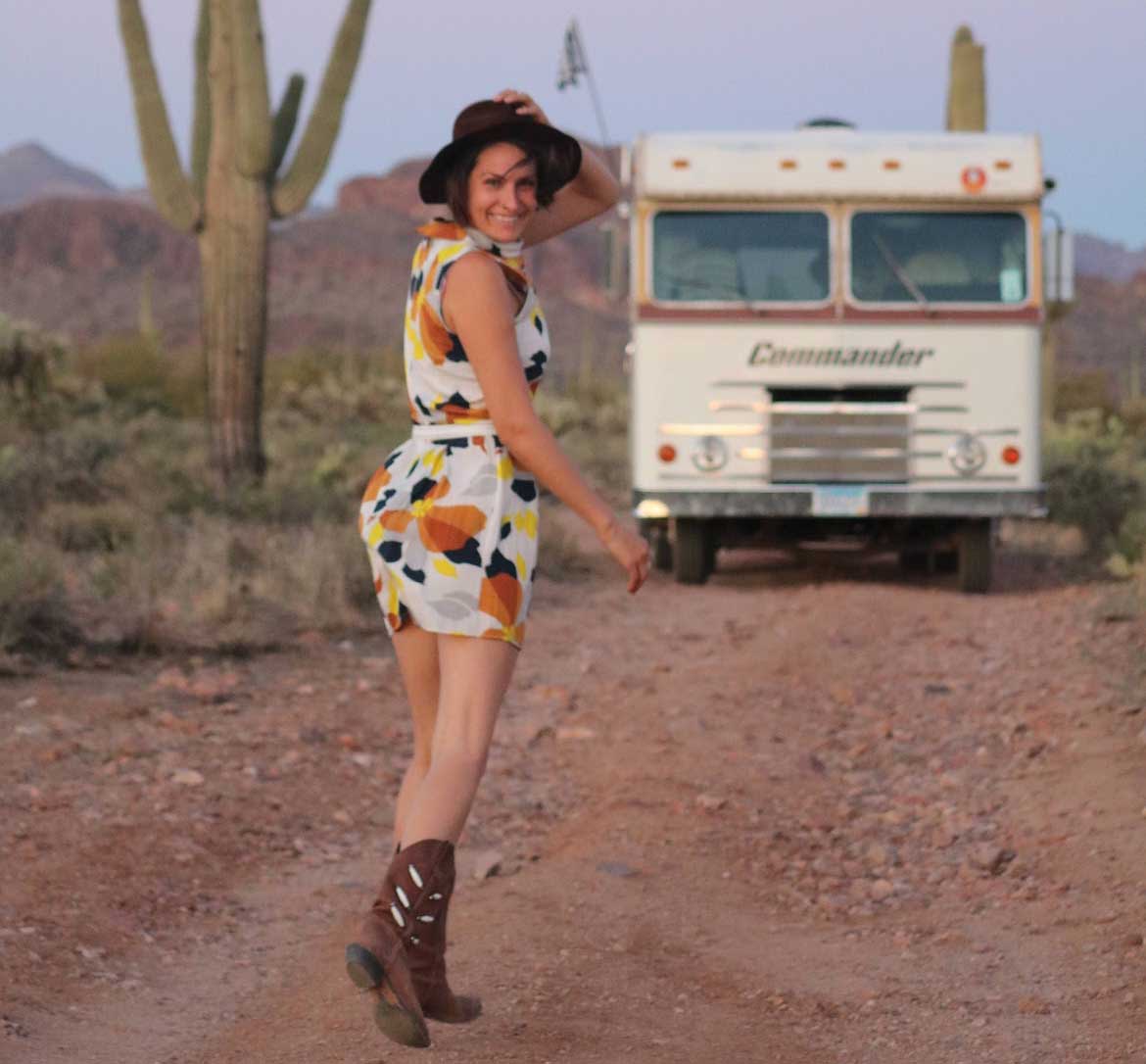 A woman walking away from the camera toward a motorhome.