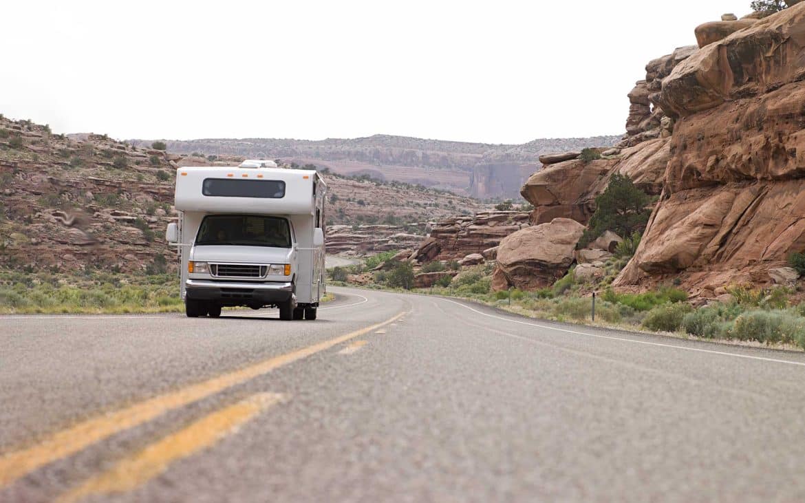 Trucks camper on a desert highway.
