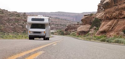 Trucks camper on a desert highway.