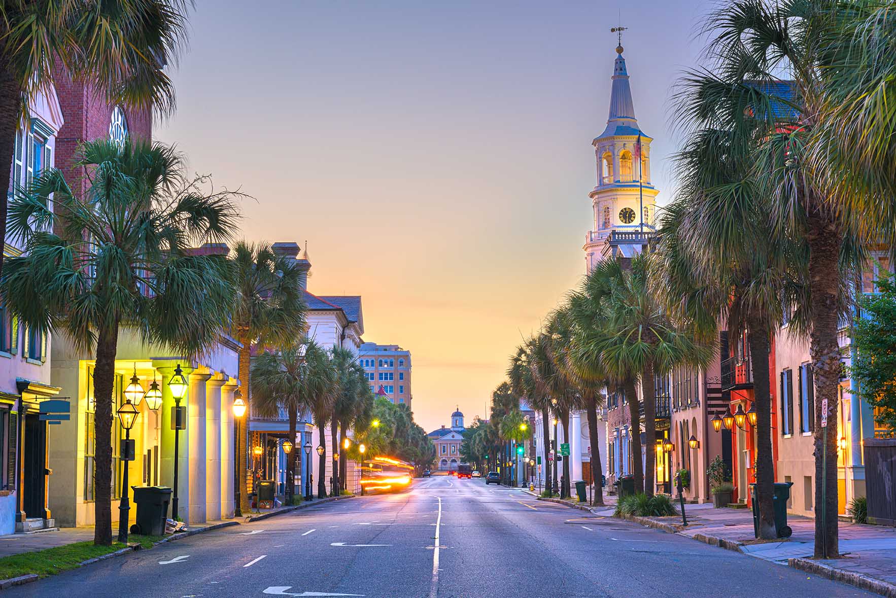 Soft evening light falls on a palm-lined street.