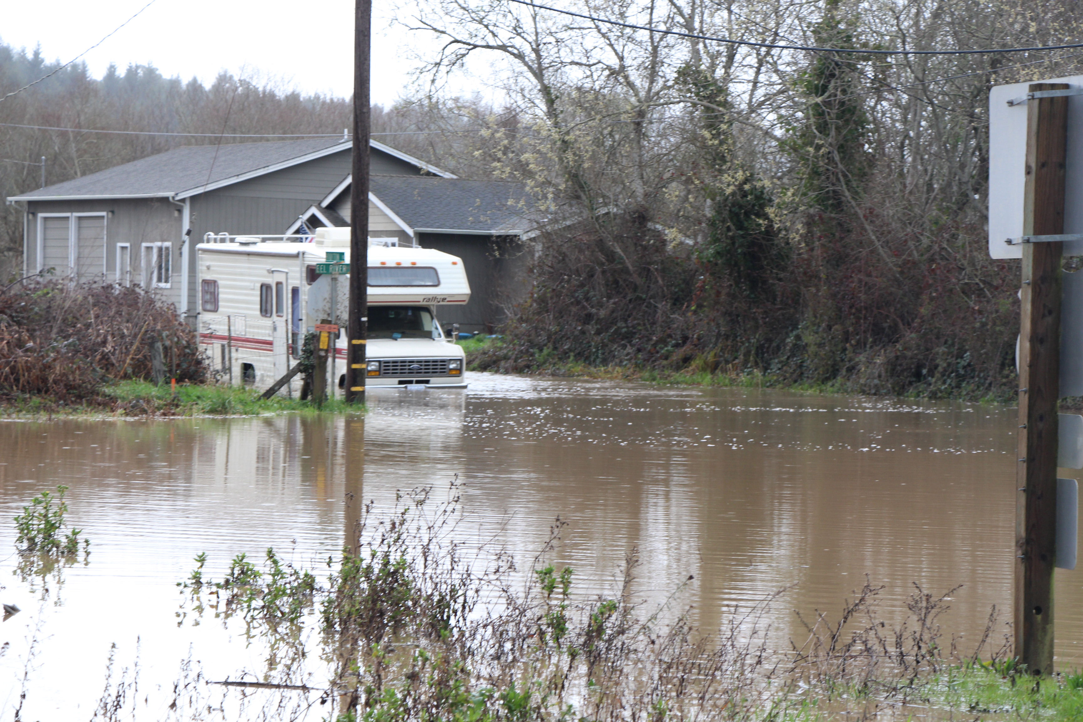 RV with flood waters up to its bumper.