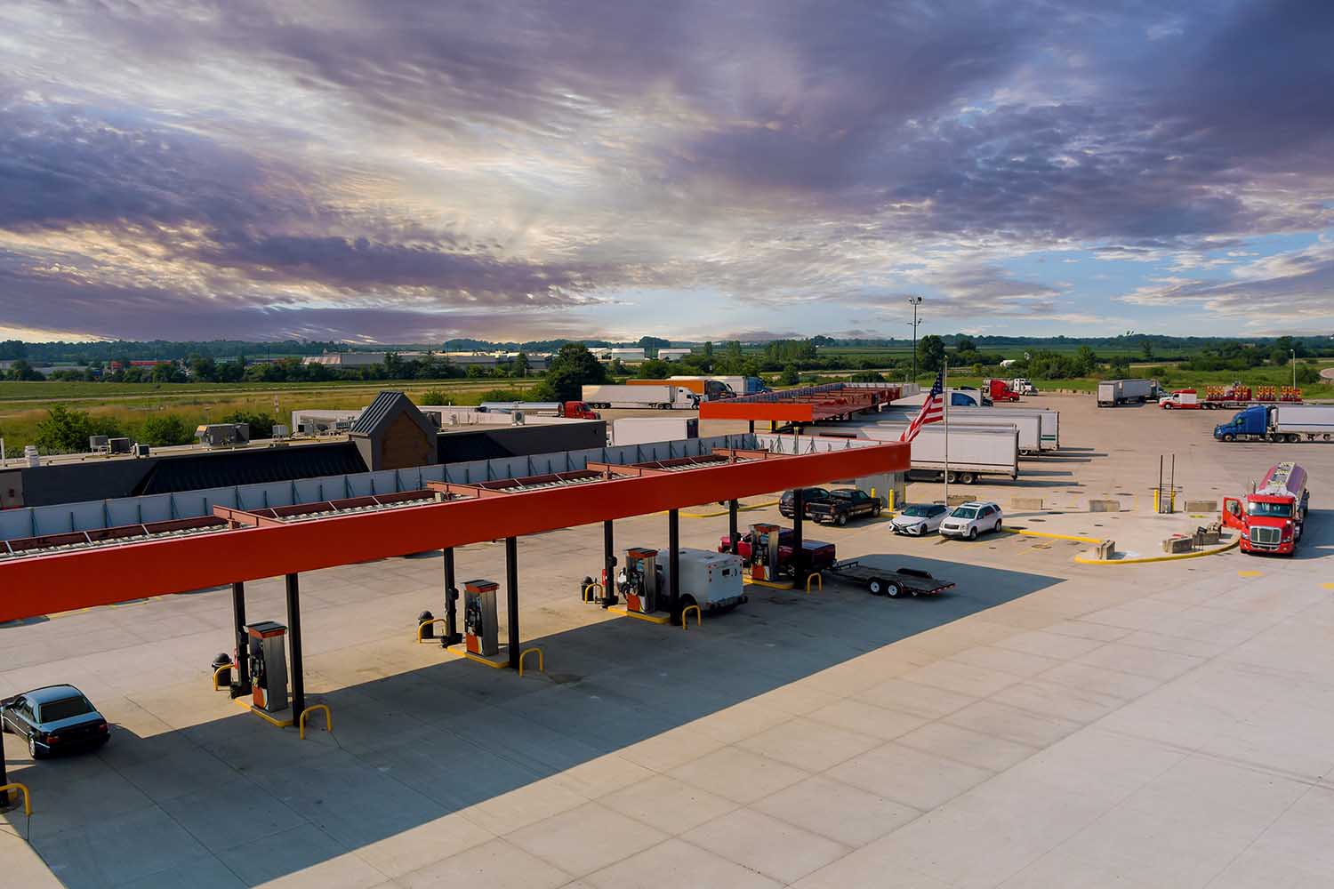 Drone view the automotive large over road semi-trucks at fueling station of the highway on USA