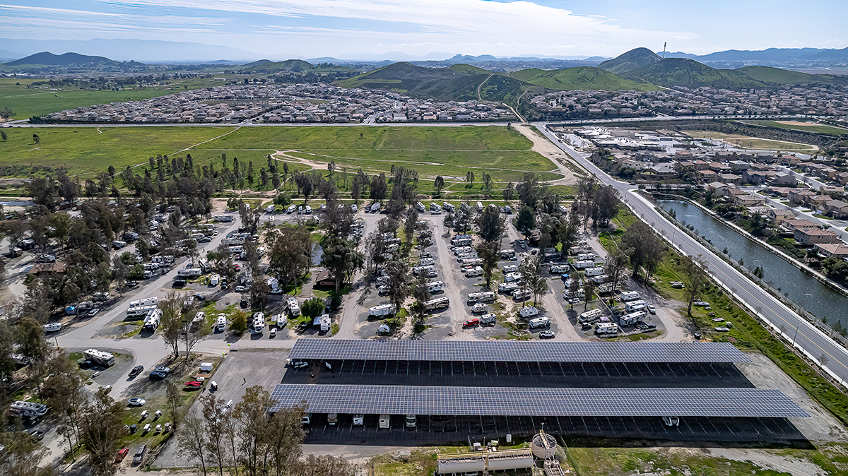 Aerial view of RV park with two large solar panels.