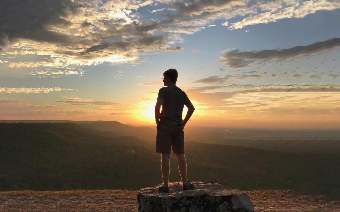 Young man looking at sunset.