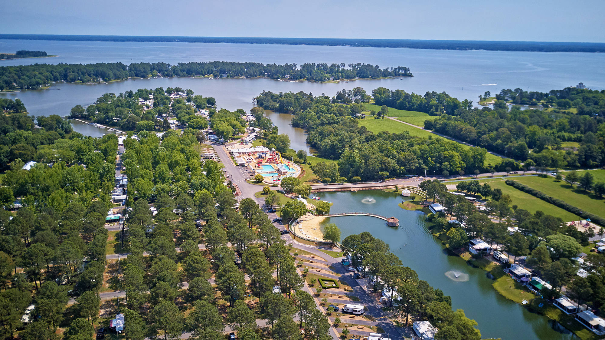 Aerial view of campground with small lake.