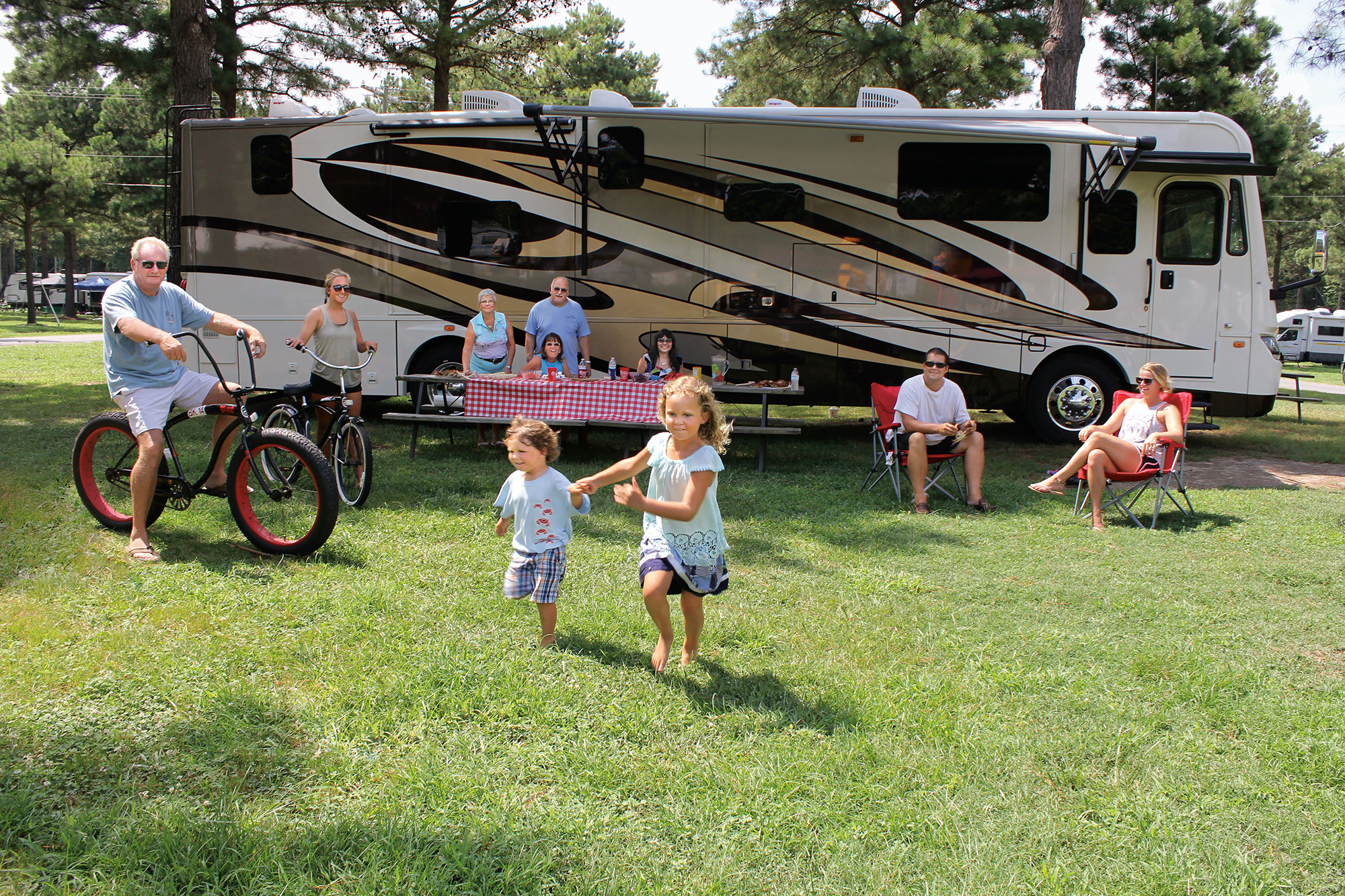 A three-generation family near a motorhome.