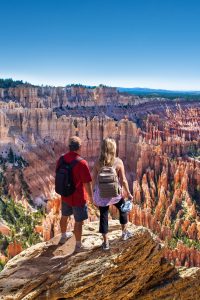 Southern Utah A couple overlook a canyon studded with sandstone monoliths.