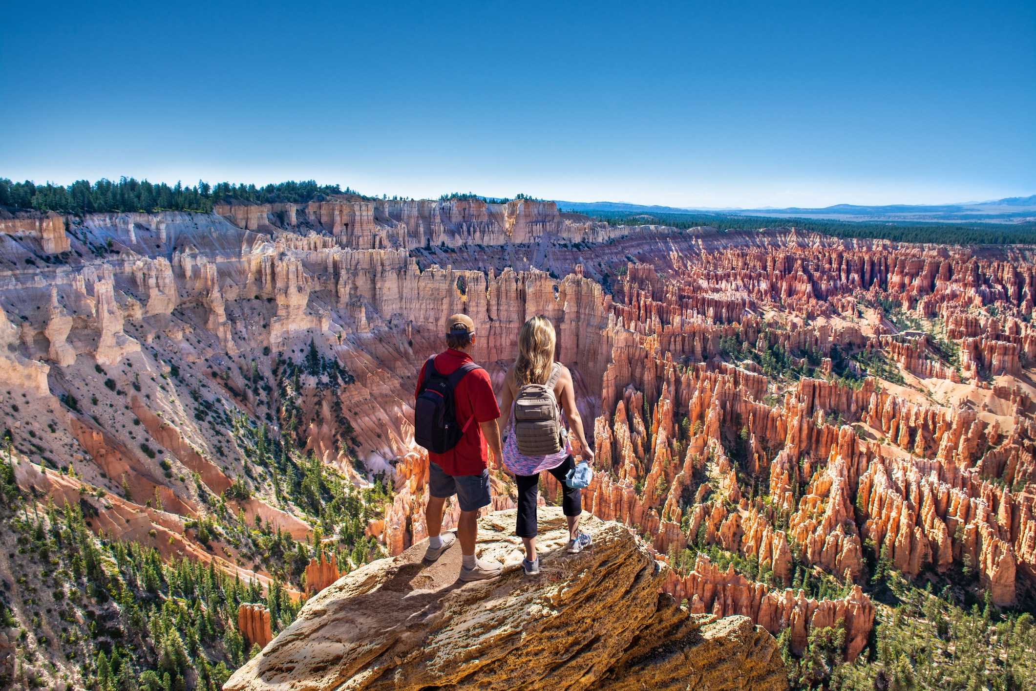 Southern Utah A couple overlook a canyon studded with sandstone monoliths.