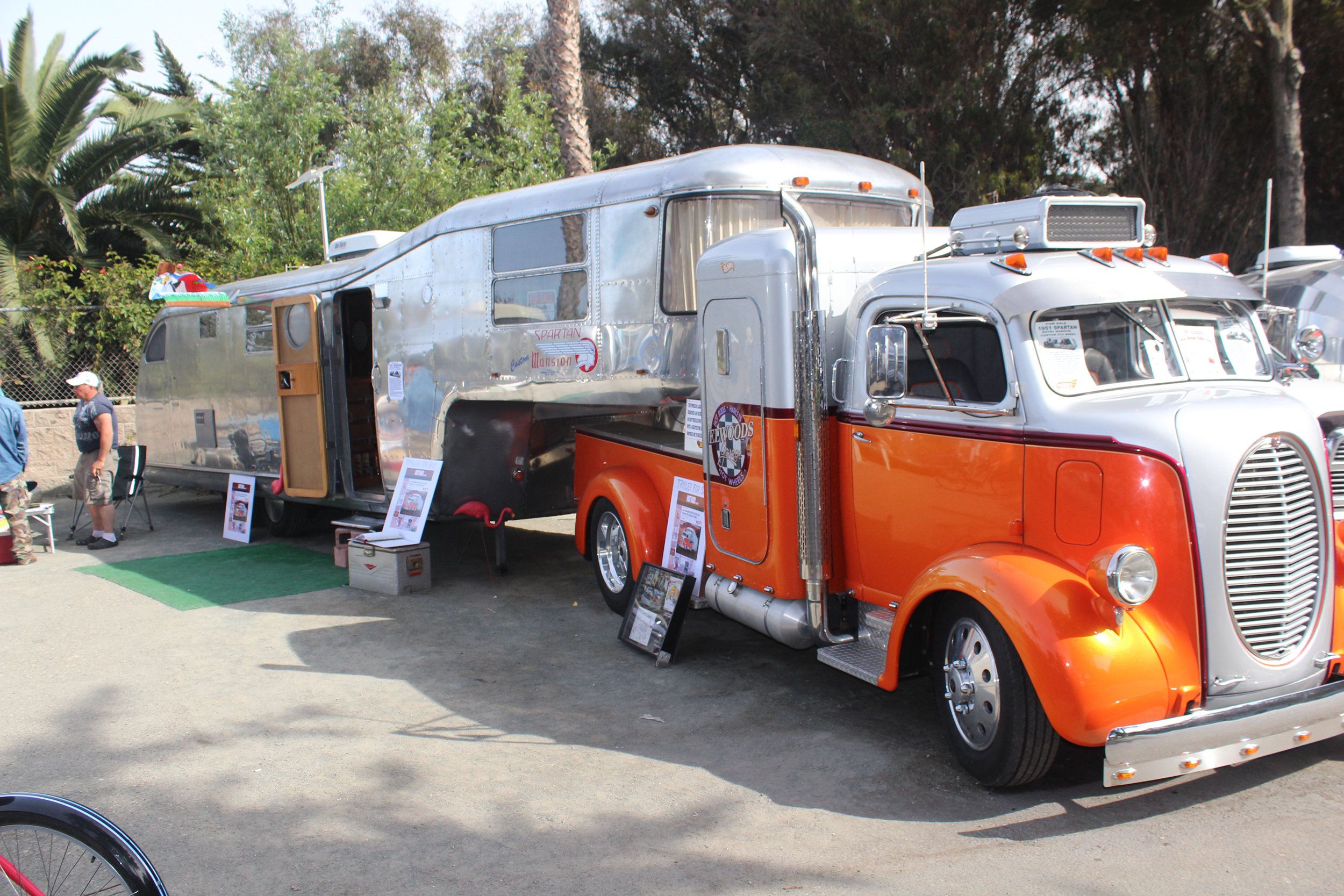 Brawny vintage tow vehicle hitched to a silver, vintage fifth-wheel.