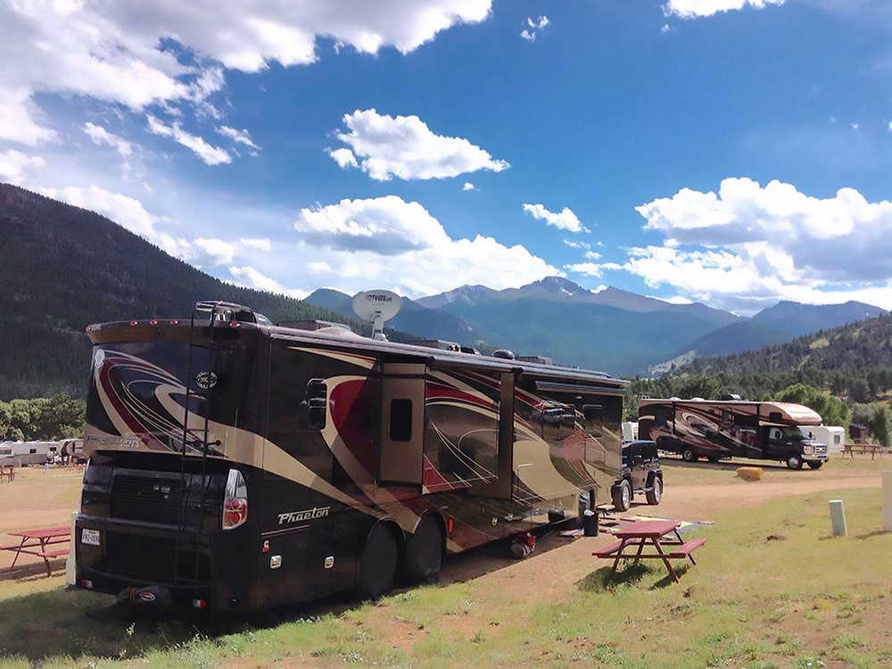 RV in campground backed by mountain range.
