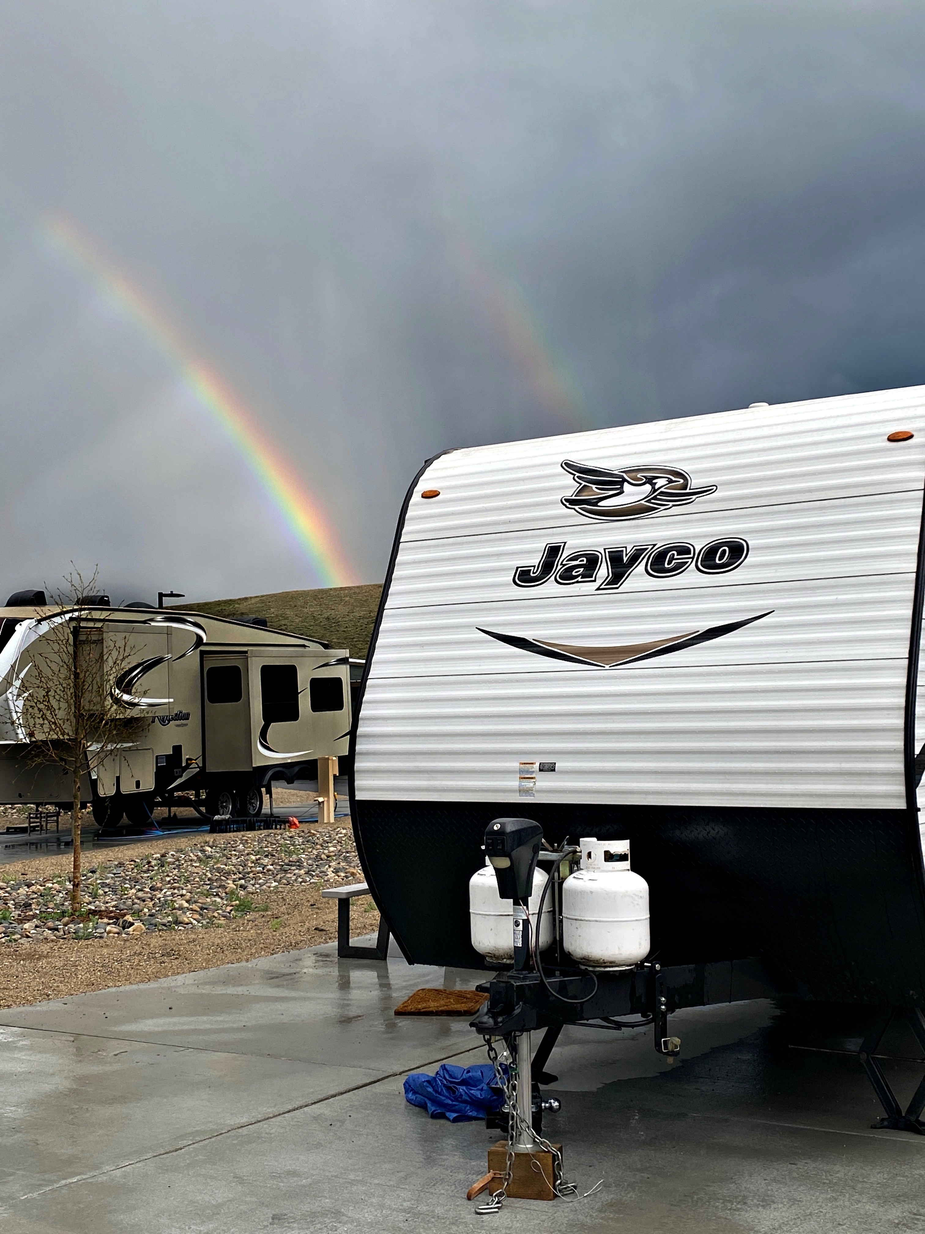RV with rainbows in background