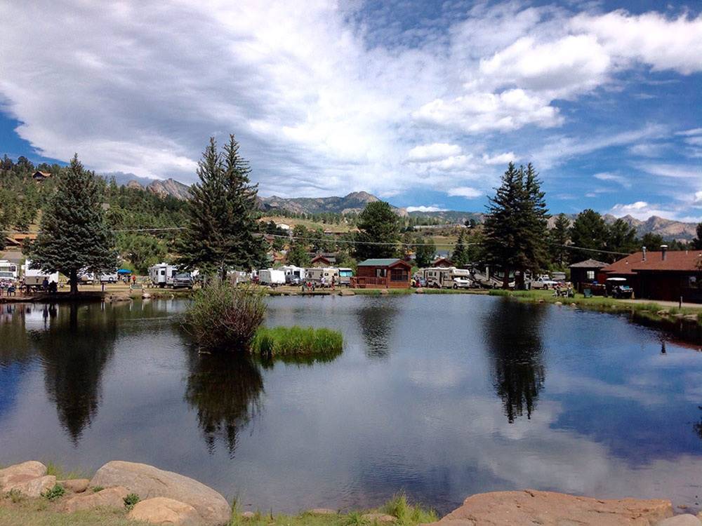 RVs camping near the banks of a lake. 