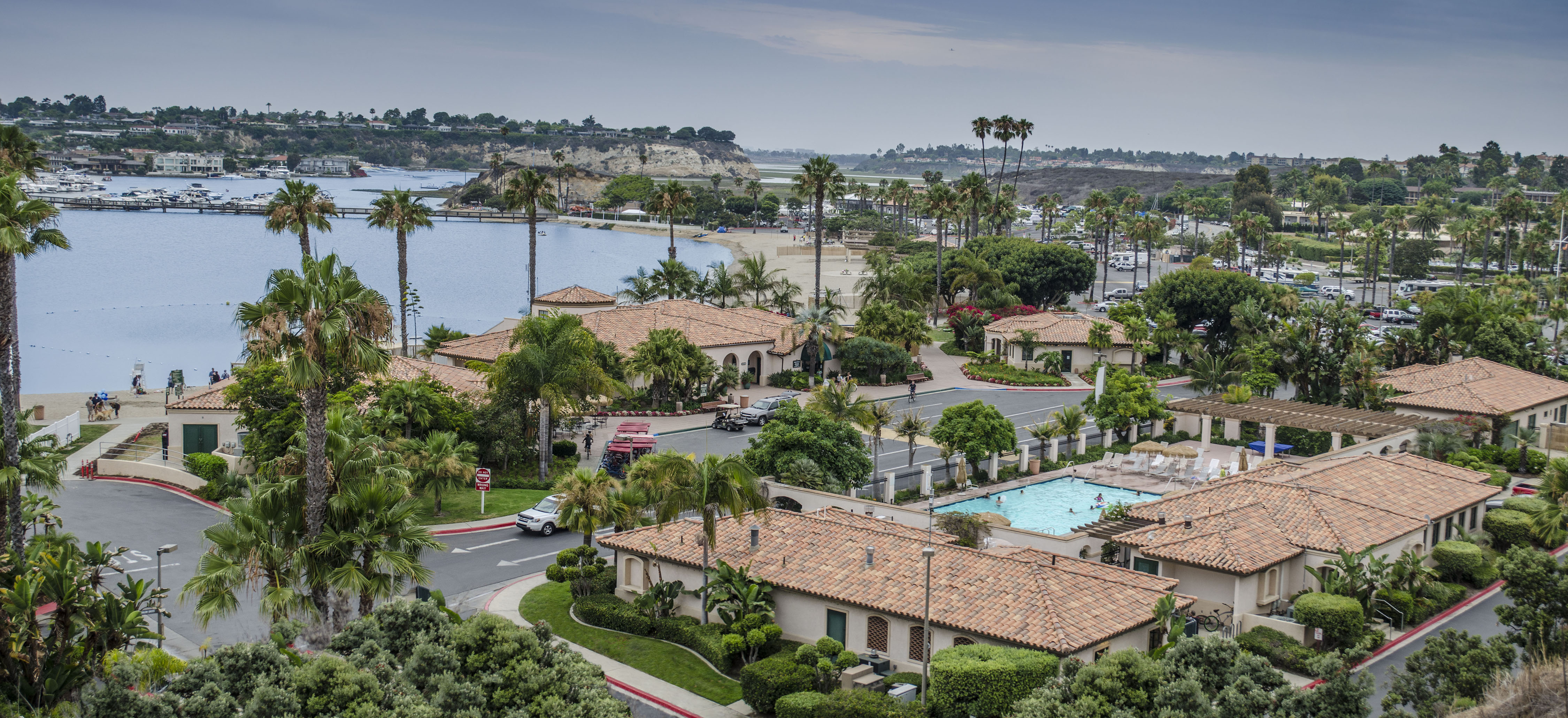 Drone shot of resort with tiled roofs and pools