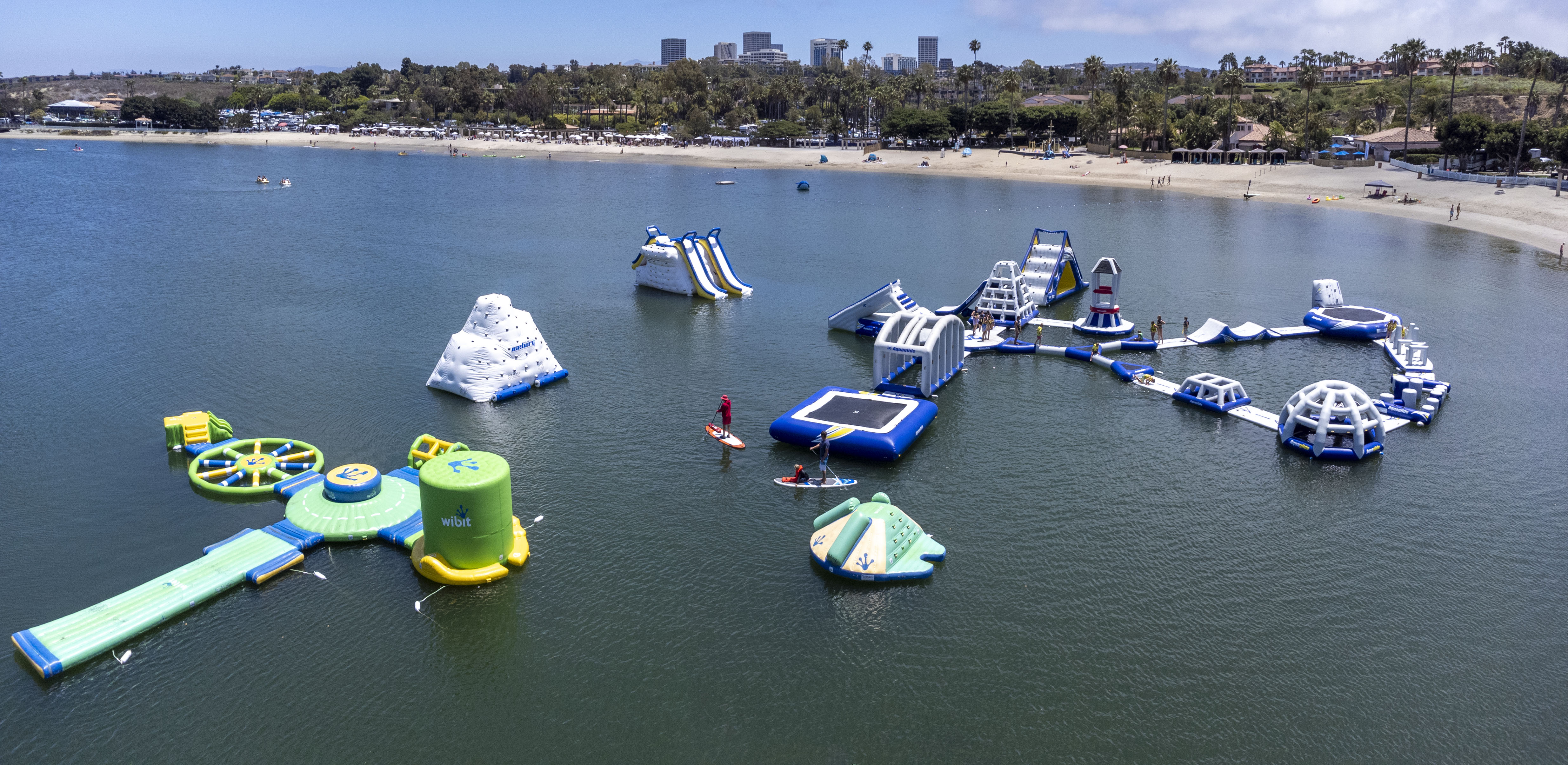 Aerial shot of floating play structures in a lagoon.
