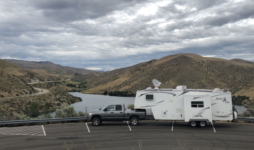 RV parked and overlooking a reservoir.