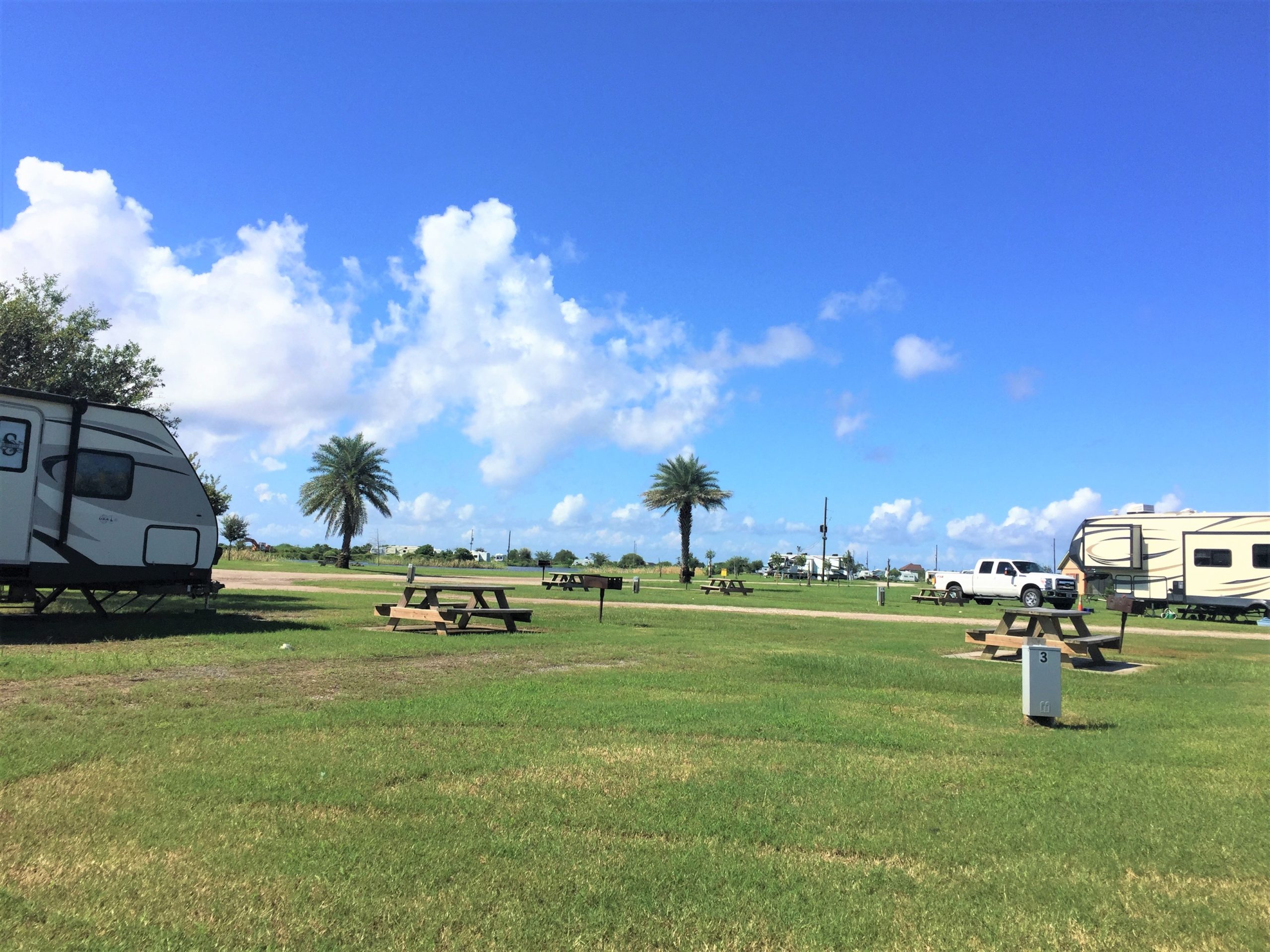 RVs parked on grassy sites separated by sprawling lawns.