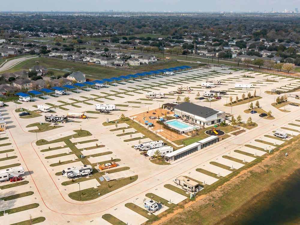 Aerial shot of sprawling RV resort with spaces arrayed around a main building.