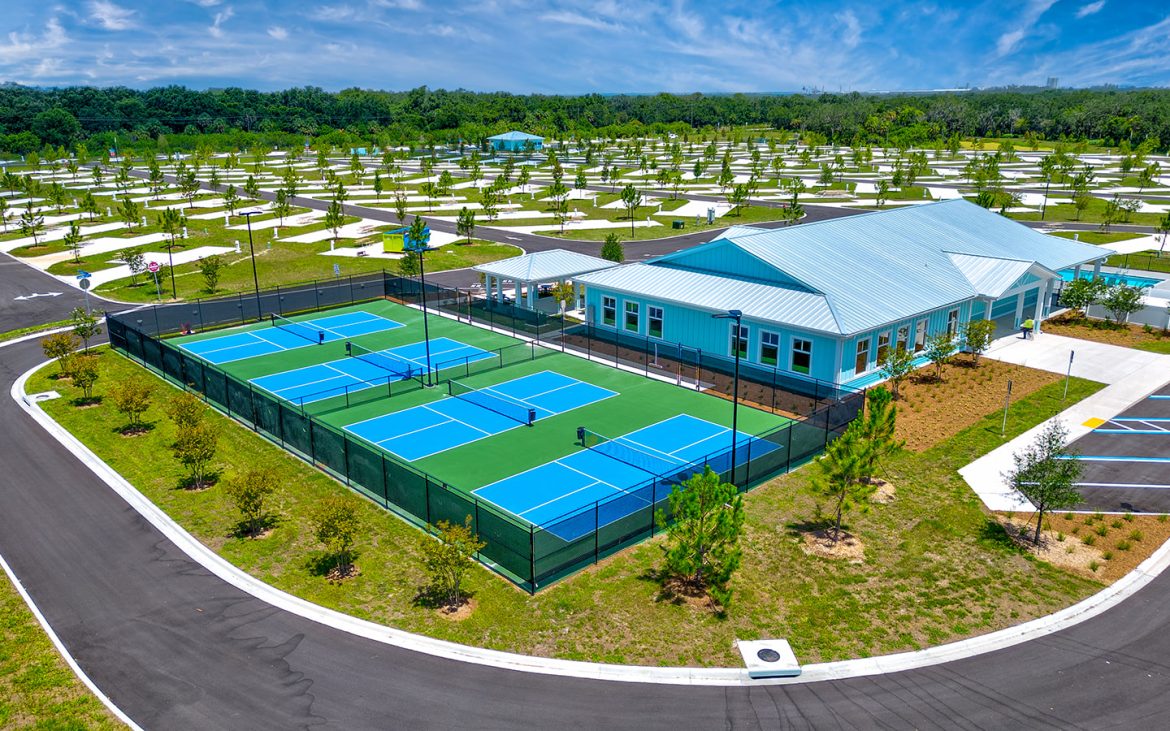 Aerial shot of RV resort with eight pickleball courts.