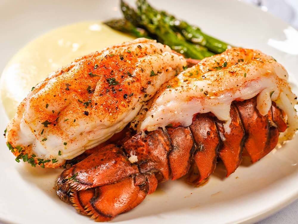 Succulent lobsters with asparagus on a plate. 