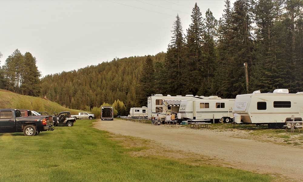 RVs parked along a dirt road. 