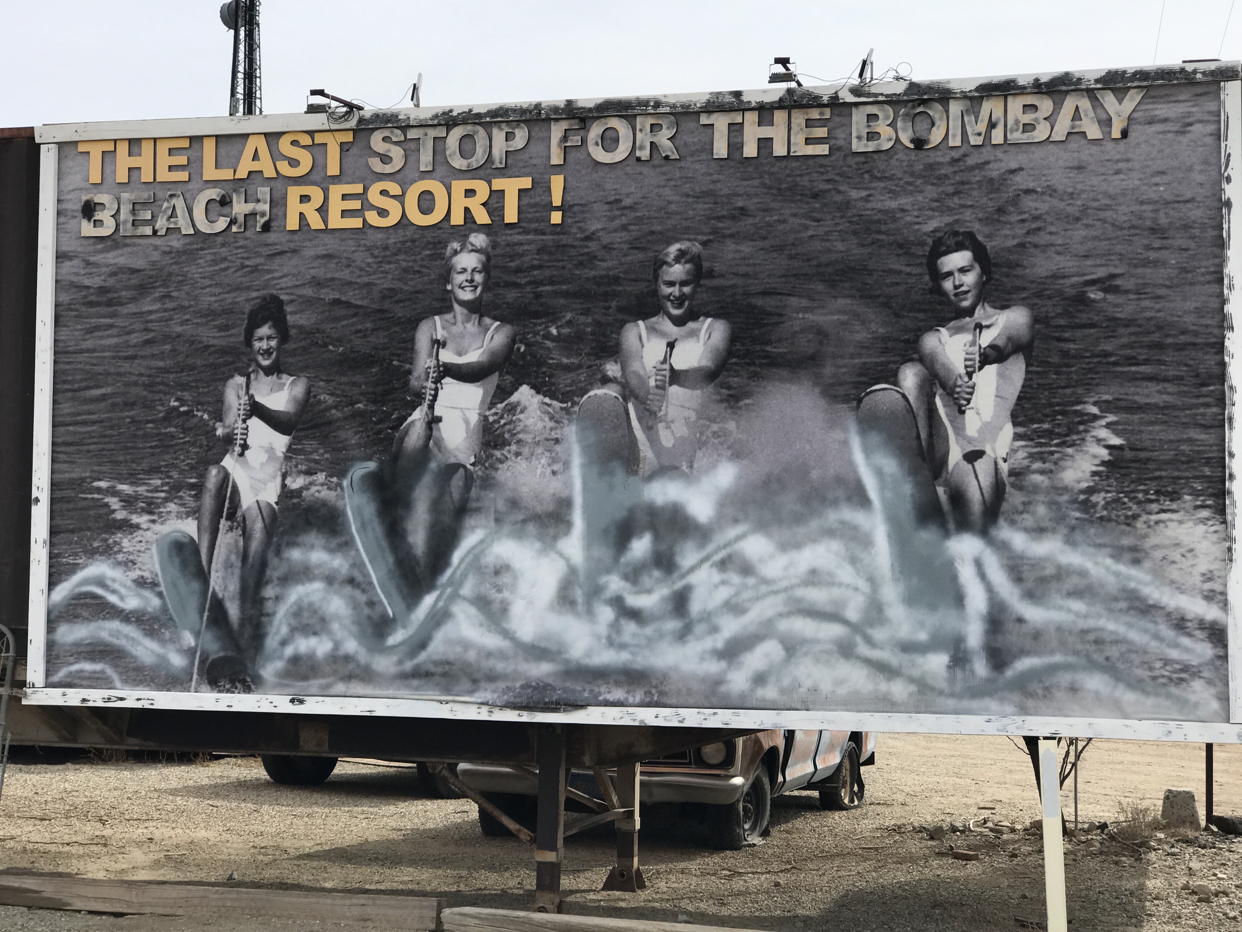 A nostalgic poster showing four waterskiers showing signs of aging.