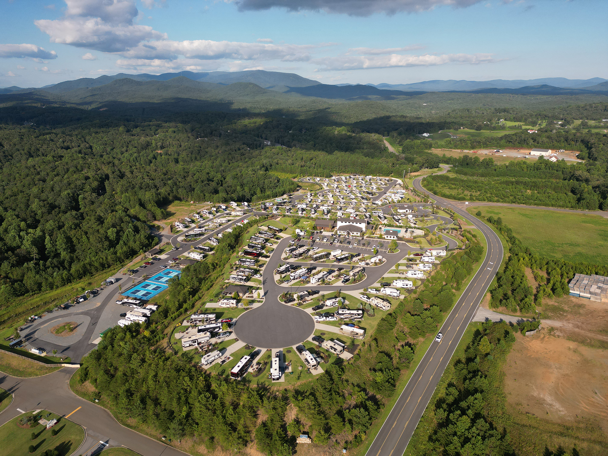Aerial view of RV resort nestled among green hills